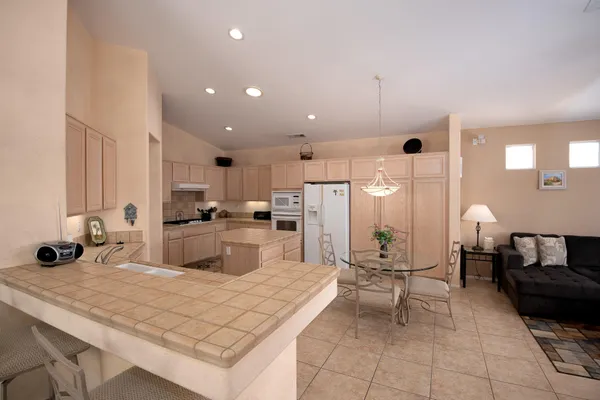 a kitchen with white cabinets and white appliances