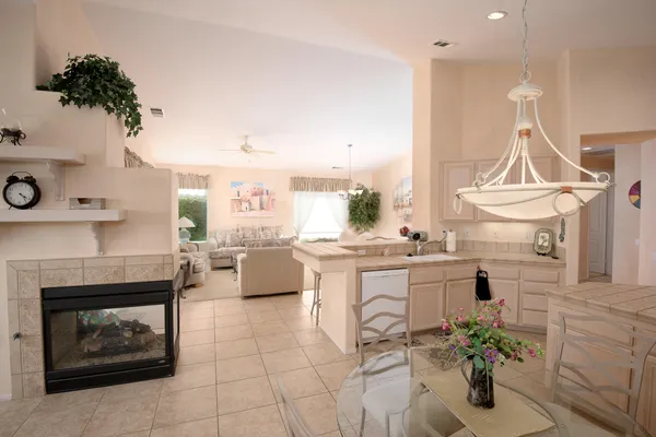 a kitchen with white cabinets and appliances