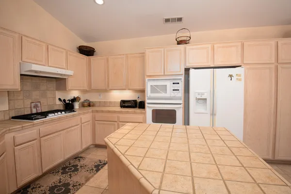 a kitchen with a sink stove and cabinets