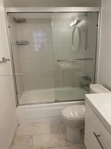 a bathroom with a shower a toilet and a sink