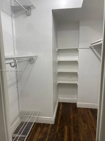 a view of walk in closet with empty racks