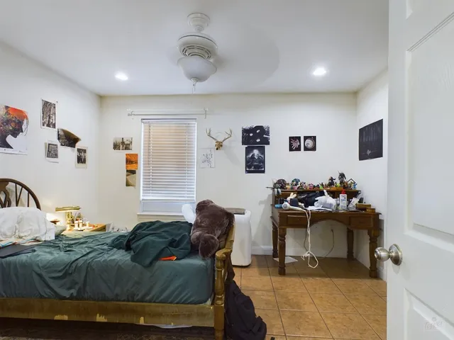 a bedroom with a bed and a couch