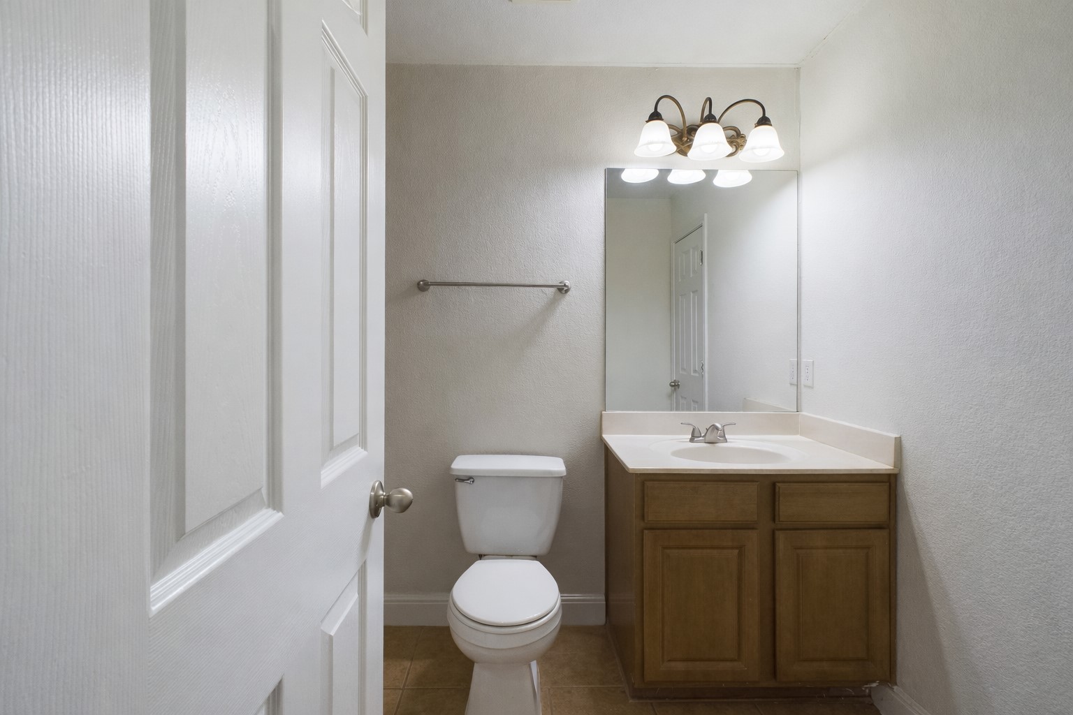 500 East 48th Street, Unit A Austin, TX 78751 - Photo 17 of 27 a bathroom with a toilet sink and mirror