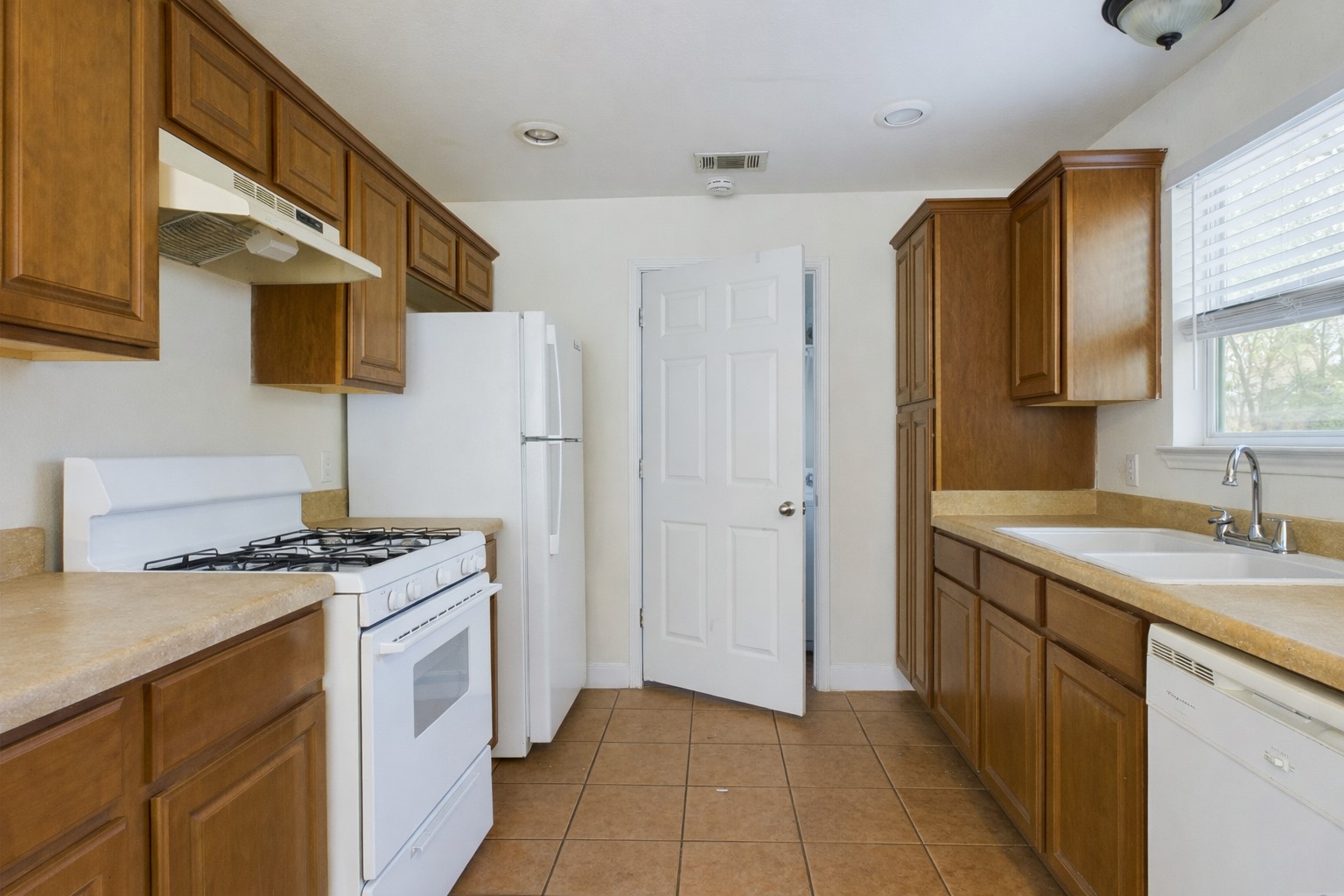 500 East 48th Street, Unit A Austin, TX 78751 - Photo 5 of 27 a kitchen with stainless steel appliances granite countertop a sink stove and refrigerator