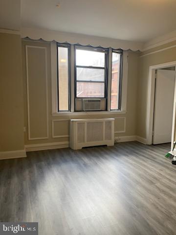 2031 Locust Street, Unit 103 Philadelphia, PA 19103 - Photo 1 of 16 an empty room with wooden floor and windows