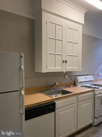 2031 Locust Street, Unit 103 Philadelphia, PA 19103 - Photo 3 of 16 a kitchen with stainless steel appliances granite countertop a sink and a white cabinets