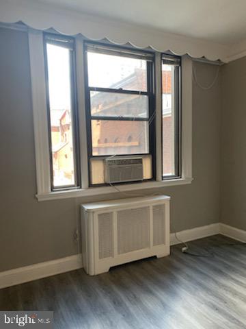 2031 Locust Street, Unit 103 Philadelphia, PA 19103 - Photo 8 of 16 a living room with wooden floors and a window
