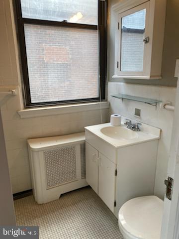 2031 Locust Street, Unit 103 Philadelphia, PA 19103 - Photo 9 of 16 a bathroom with a sink a toilet and mirror