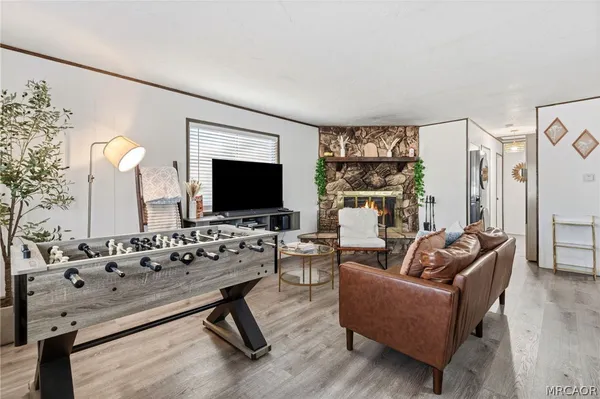 a kitchen with stainless steel appliances kitchen island granite countertop a table chairs and refrigerator