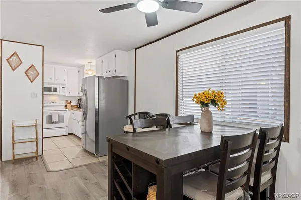 a kitchen with cabinets stainless steel appliances and a refrigerator
