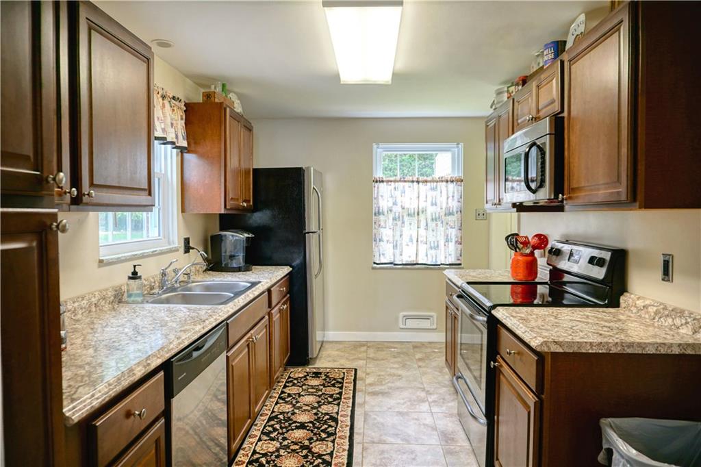 104 Church Road Butler, PA 16002 - Photo 8 of 21 a kitchen with granite countertop a sink stove and refrigerator