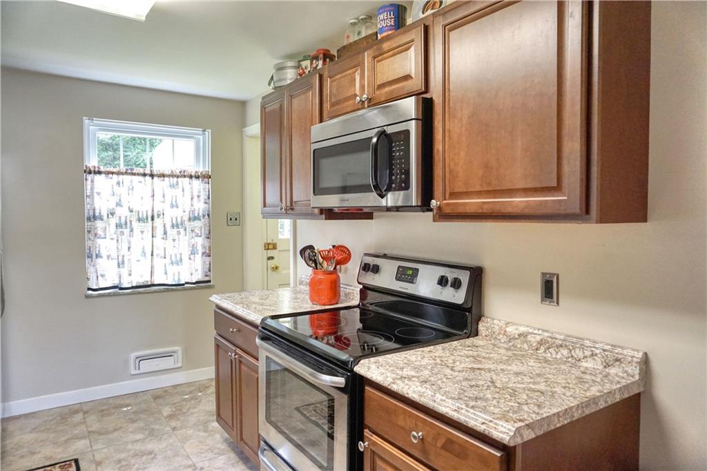 104 Church Road Butler, PA 16002 - Photo 10 of 21 a kitchen with stainless steel appliances granite countertop a stove and a microwave