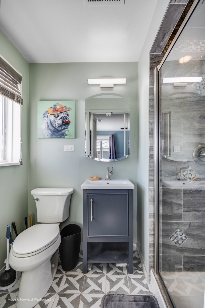 214 Springinsguth Road Schaumburg, IL 60193 - Photo 12 of 29 a bathroom with a sink toilet and shower