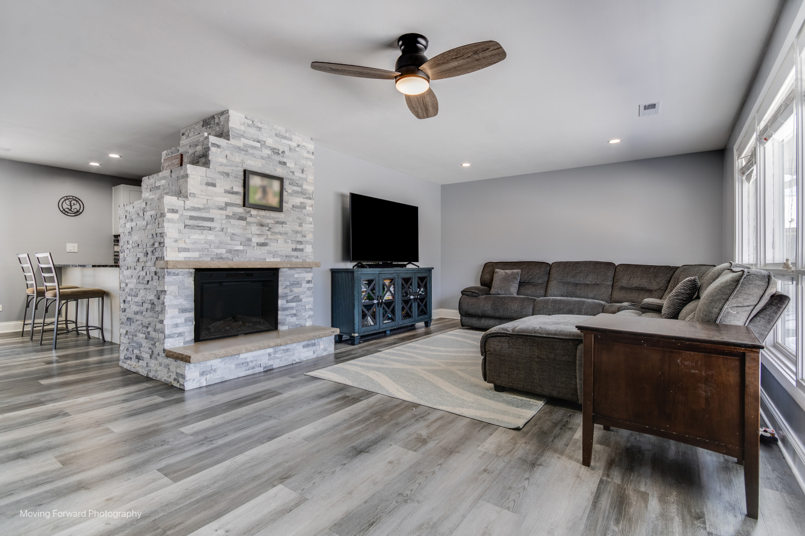214 Springinsguth Road Schaumburg, IL 60193 - Photo 19 of 29 a living room with furniture a fireplace and a flat screen tv
