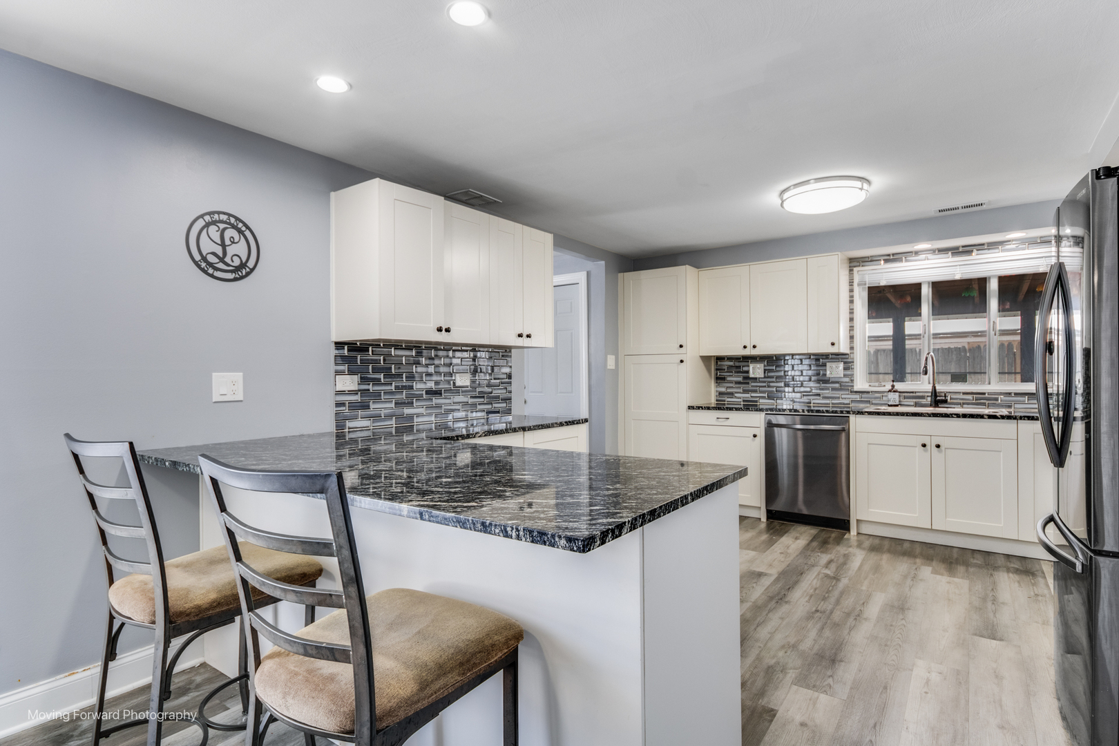214 Springinsguth Road Schaumburg, IL 60193 - Photo 5 of 29 a kitchen with kitchen island a counter top space cabinets and stainless steel appliances