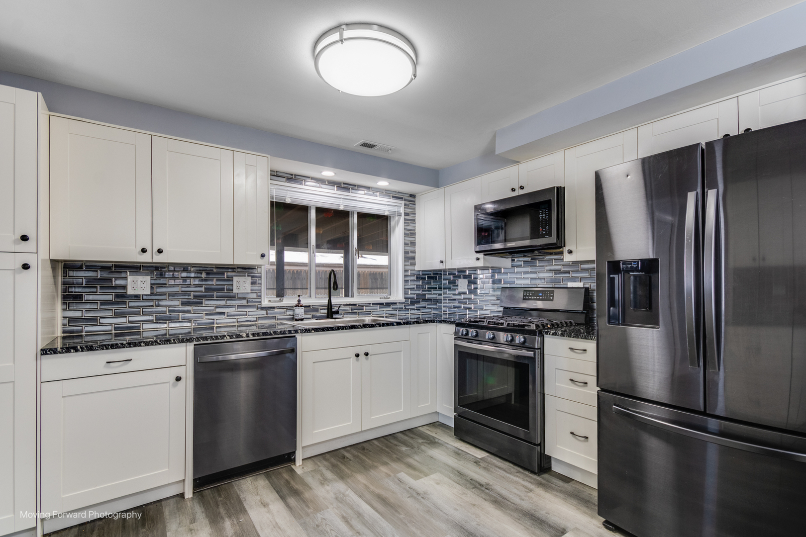 214 Springinsguth Road Schaumburg, IL 60193 - Photo 6 of 29 a kitchen with stainless steel appliances granite countertop a stove top oven a refrigerator and white cabinets