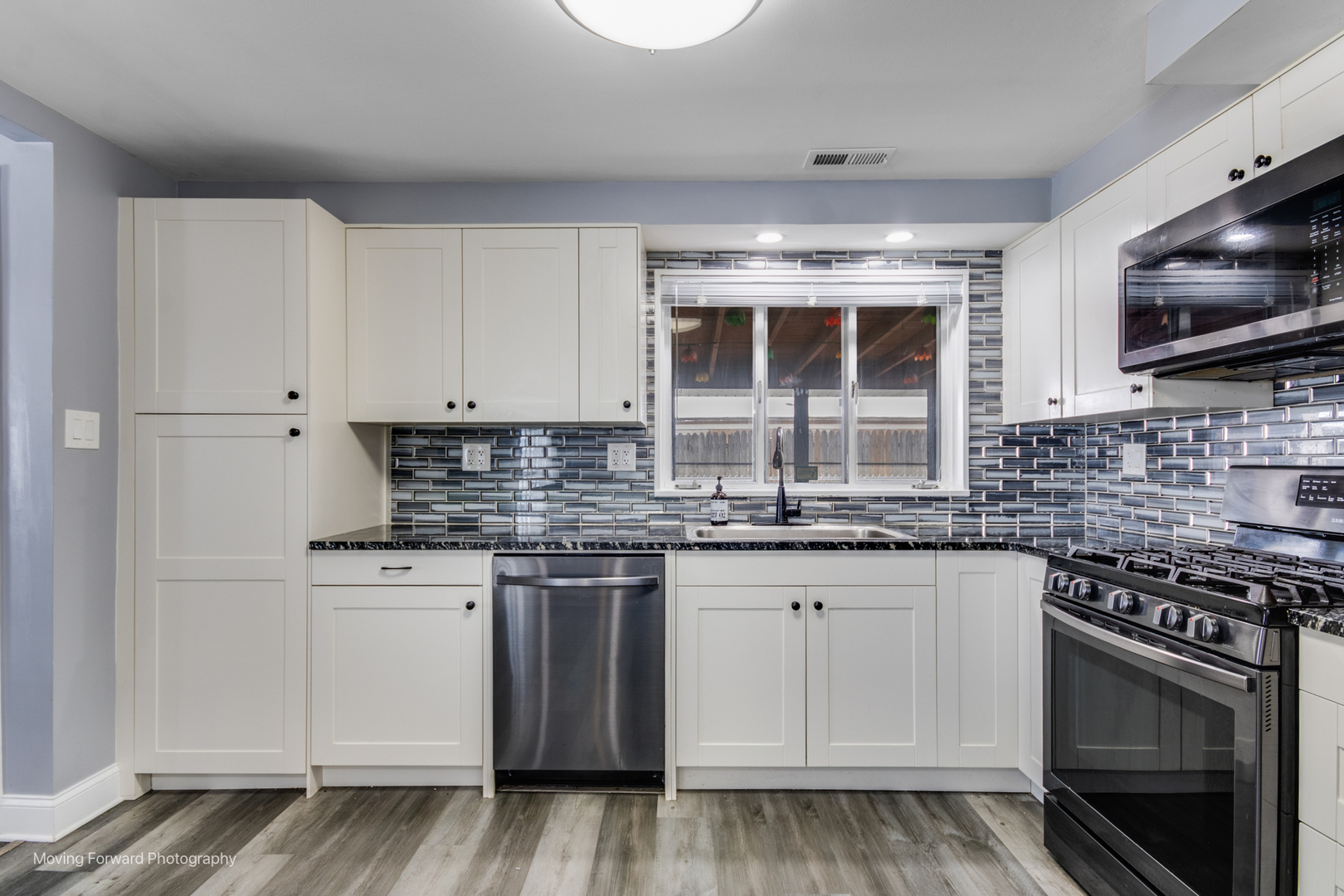 214 Springinsguth Road Schaumburg, IL 60193 - Photo 9 of 29 a kitchen with stainless steel appliances granite countertop a stove and a microwave