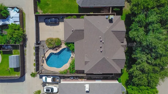 an aerial view of a house with garden space and street view