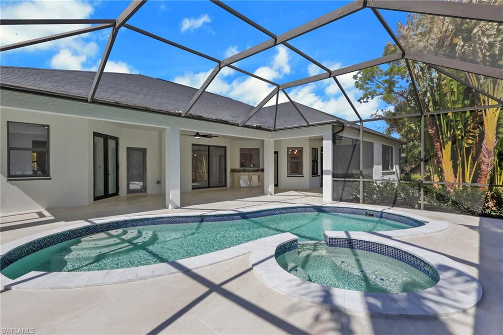 730 29th Street Southwest Naples, FL 34117 - Photo 38 of 50 Integrated pool / spa with a sunroom, a lanai, and a patio