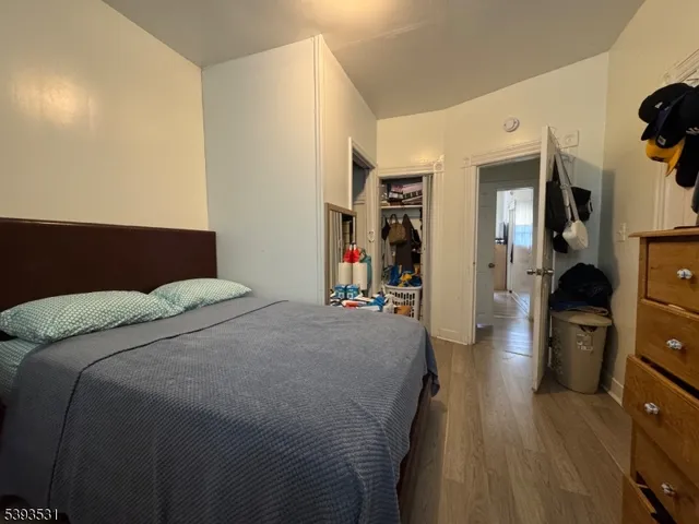 a bedroom with a bed and a flat tv screen on the dresser