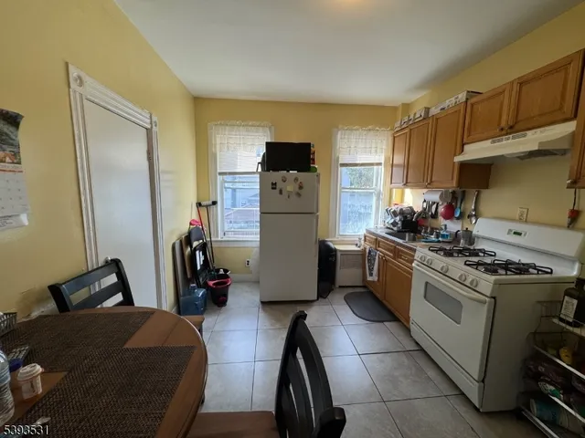 a kitchen with a stove a refrigerator and a sink
