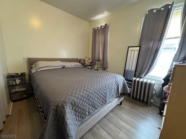 a bedroom with a bed and a mirror