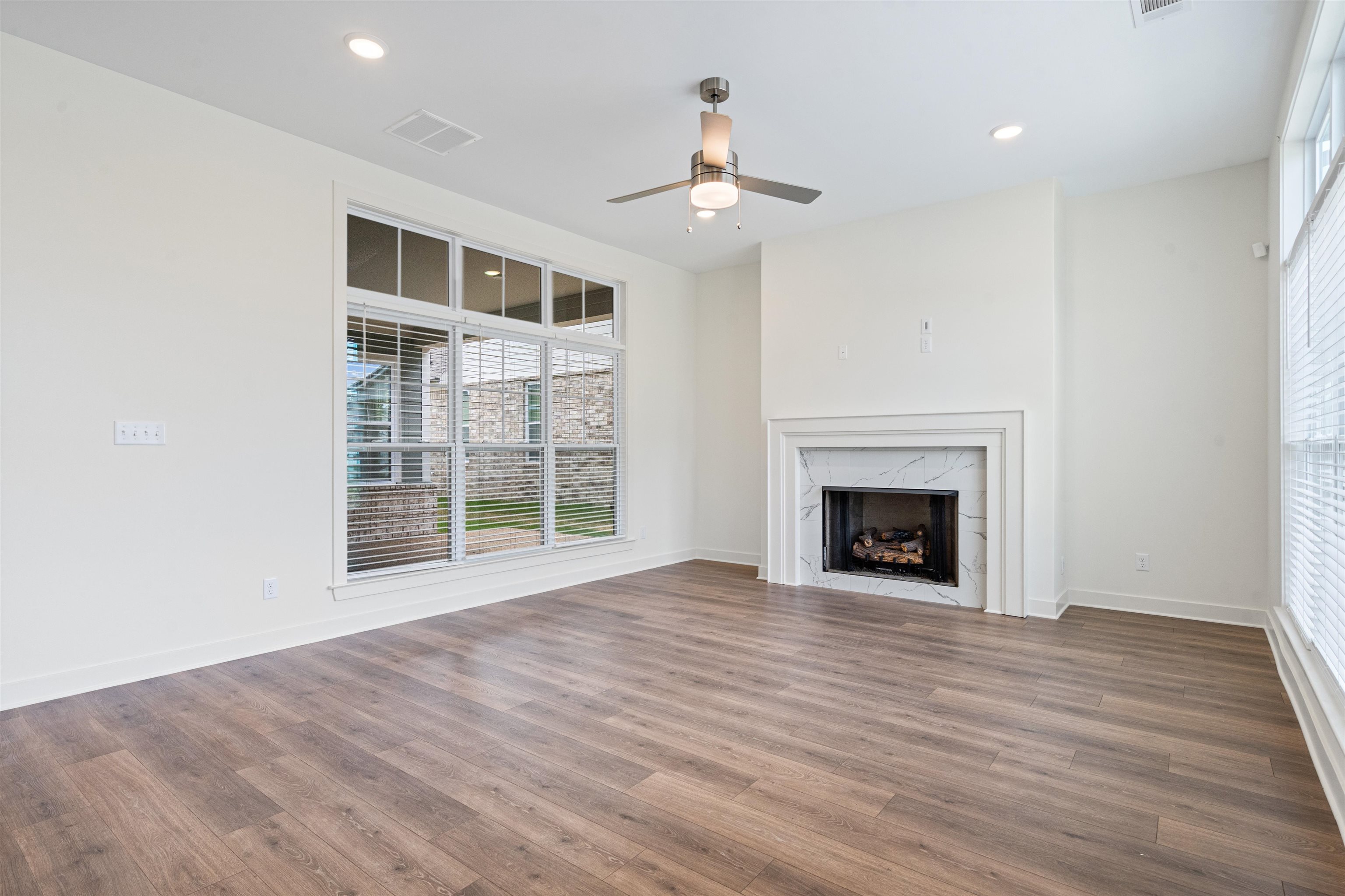 5698 Gerber Road Arlington, TN 38002 - Photo 7 of 29 Unfurnished living room with ceiling fan, dark wood-style flooring, a fireplace, and recessed lighting