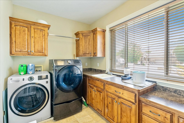316 Azure Circle Draper, UT 84020 - Photo 29 of 48 Dedicated laundry space featuring wood cabinetry, a utility sink, ample counter space, a clothing rod, and window with blinds
