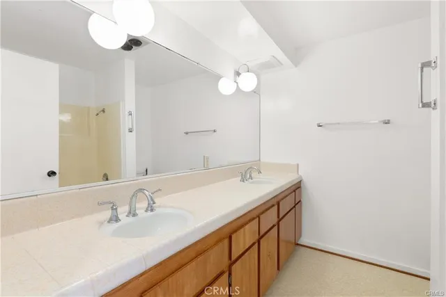 a bathroom with a sink vanity and a mirror