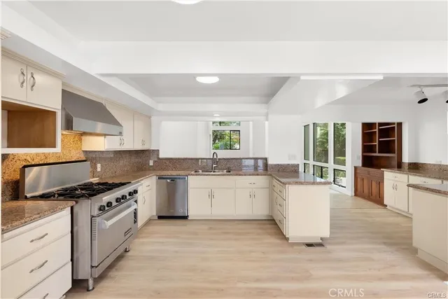 a kitchen with a sink stove and cabinets
