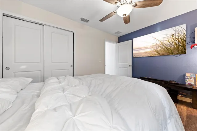 a bedroom with a bed and a chandelier