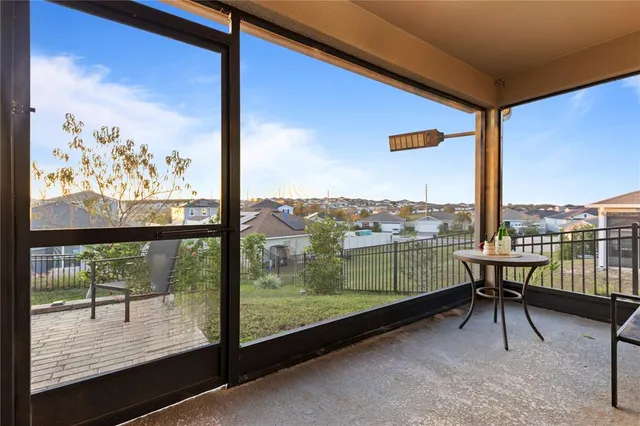 a view of a balcony with chairs and a table
