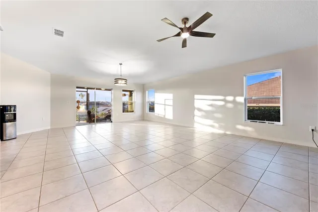 a view of a livingroom with furniture ceiling fan and windows