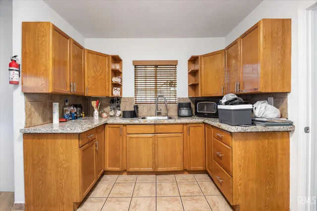 a kitchen with a sink stove and cabinets