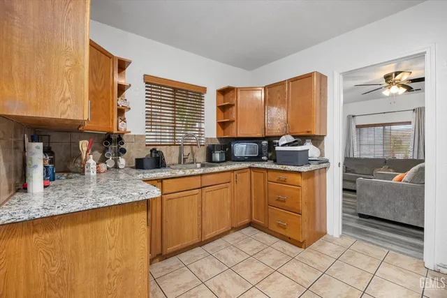 a kitchen with stainless steel appliances granite countertop a sink and cabinets