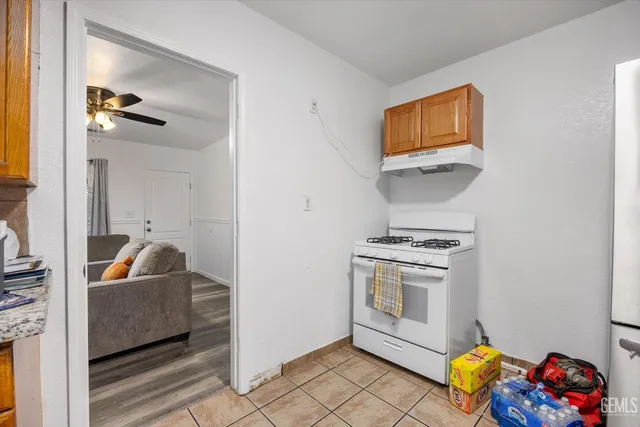a living room with a couch and a potted plant on a counter top