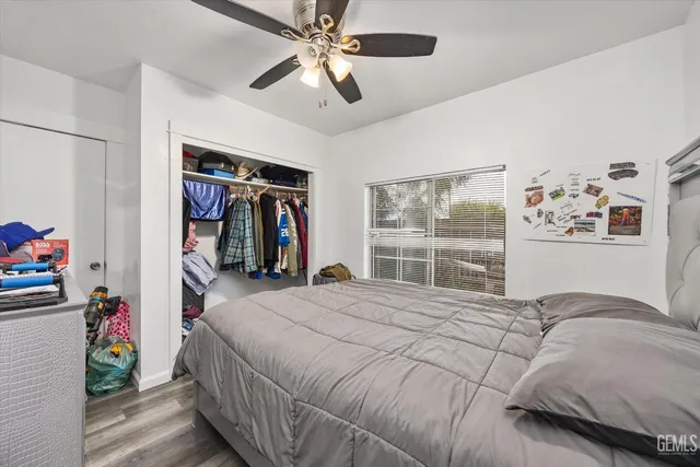 a bedroom with a large bed and a window