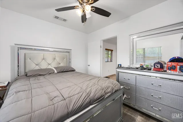 a bedroom with a large bed and a chandelier