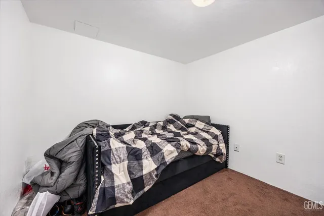 a bed sitting in a bedroom next to a window