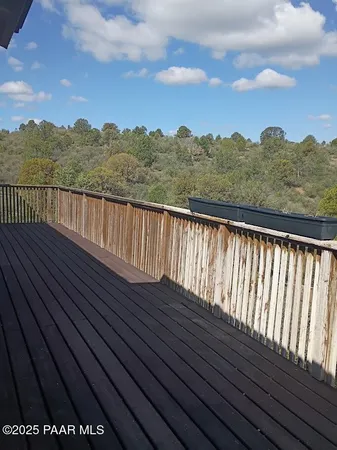 a view of balcony with wooden floor and city view