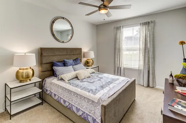 a bedroom with a bed and window