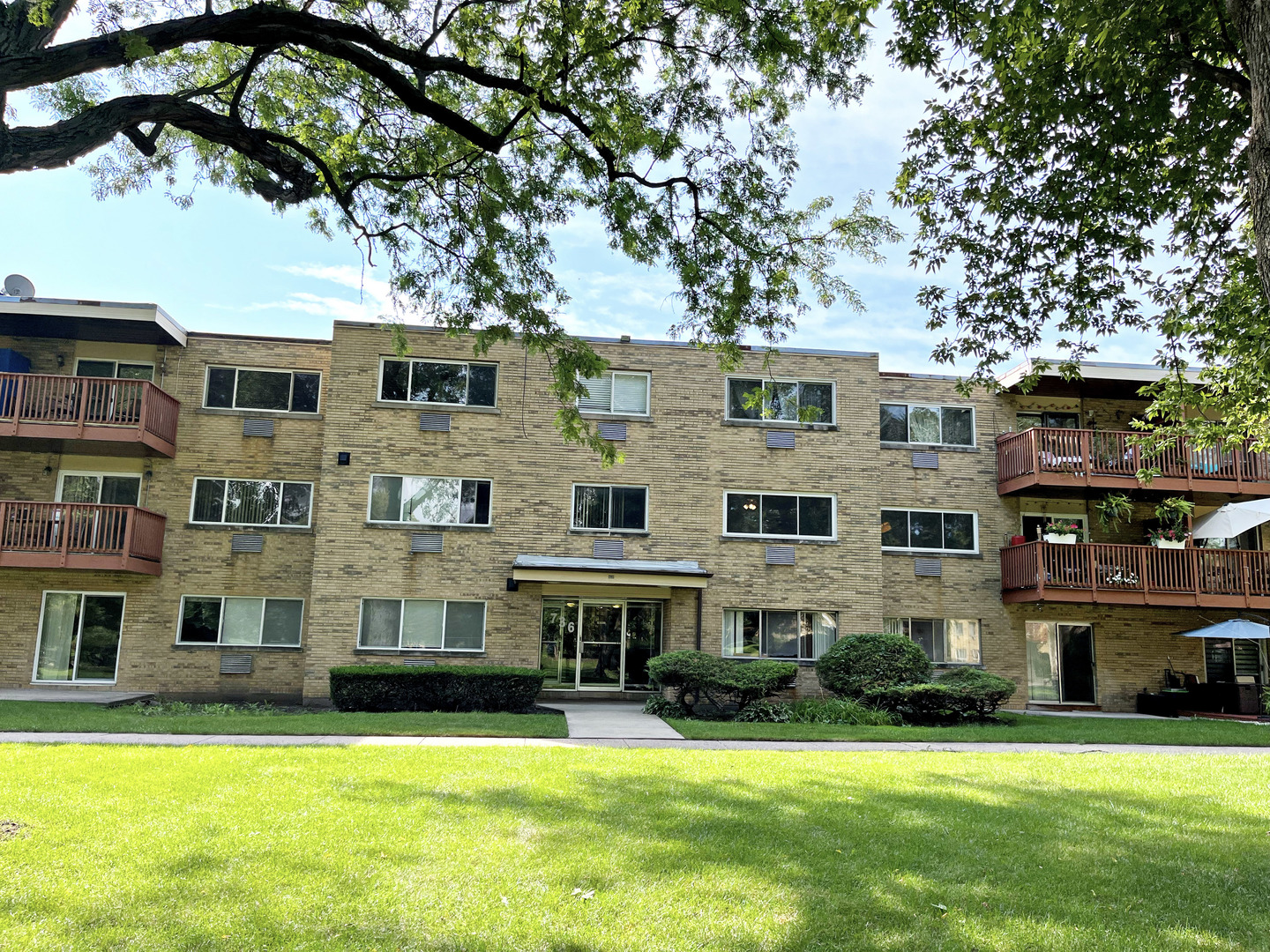736 Dempster Street, Unit 110 Mount Prospect, IL 60056 - Photo 1 of 20 a view of a building with a yard