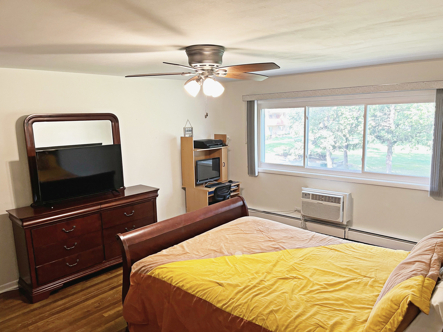 736 Dempster Street, Unit 110 Mount Prospect, IL 60056 - Photo 11 of 20 a bedroom with a bed and a flat screen tv