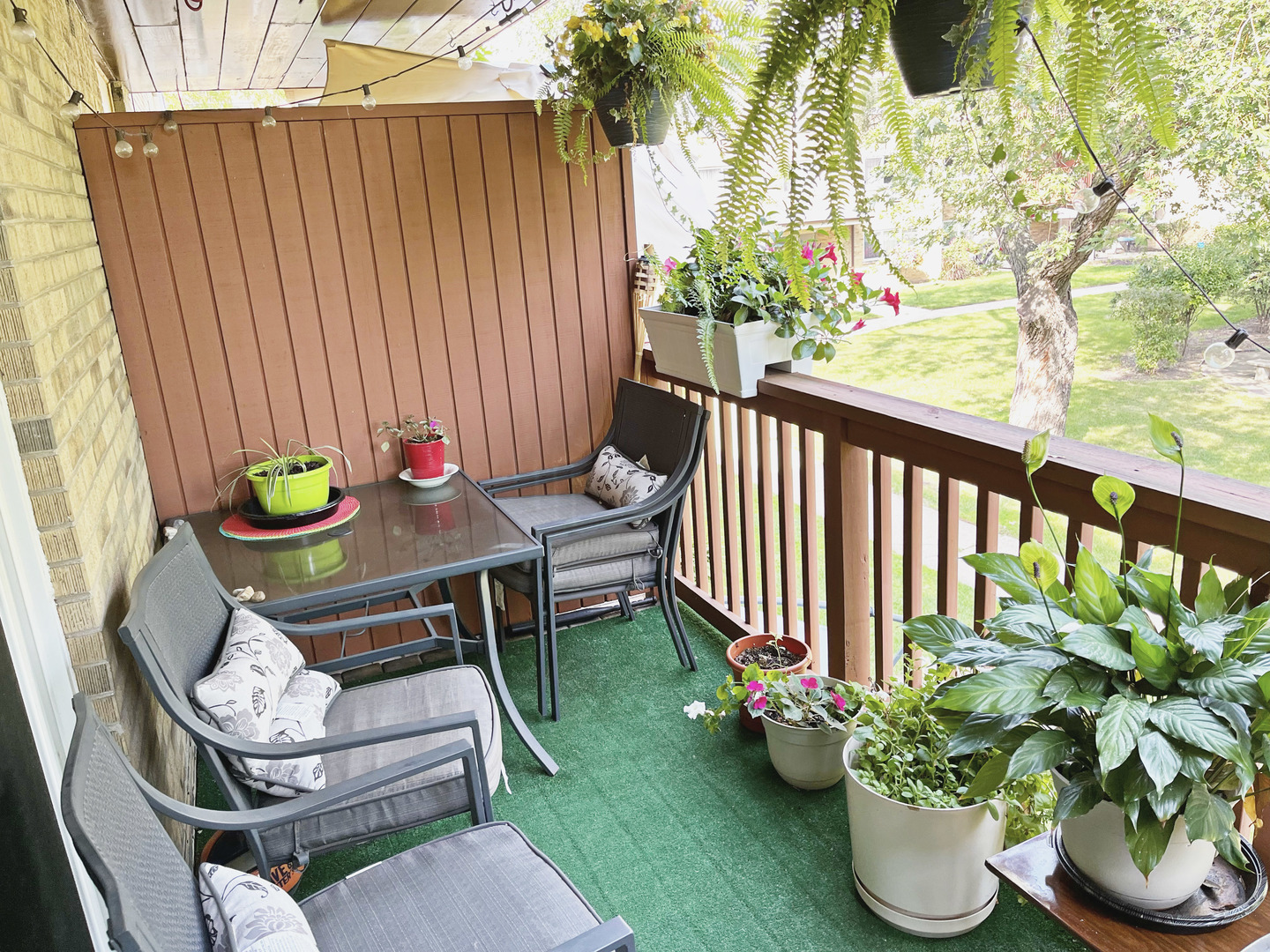 736 Dempster Street, Unit 110 Mount Prospect, IL 60056 - Photo 14 of 20 a chair and table sitting in backyard with wooden fence