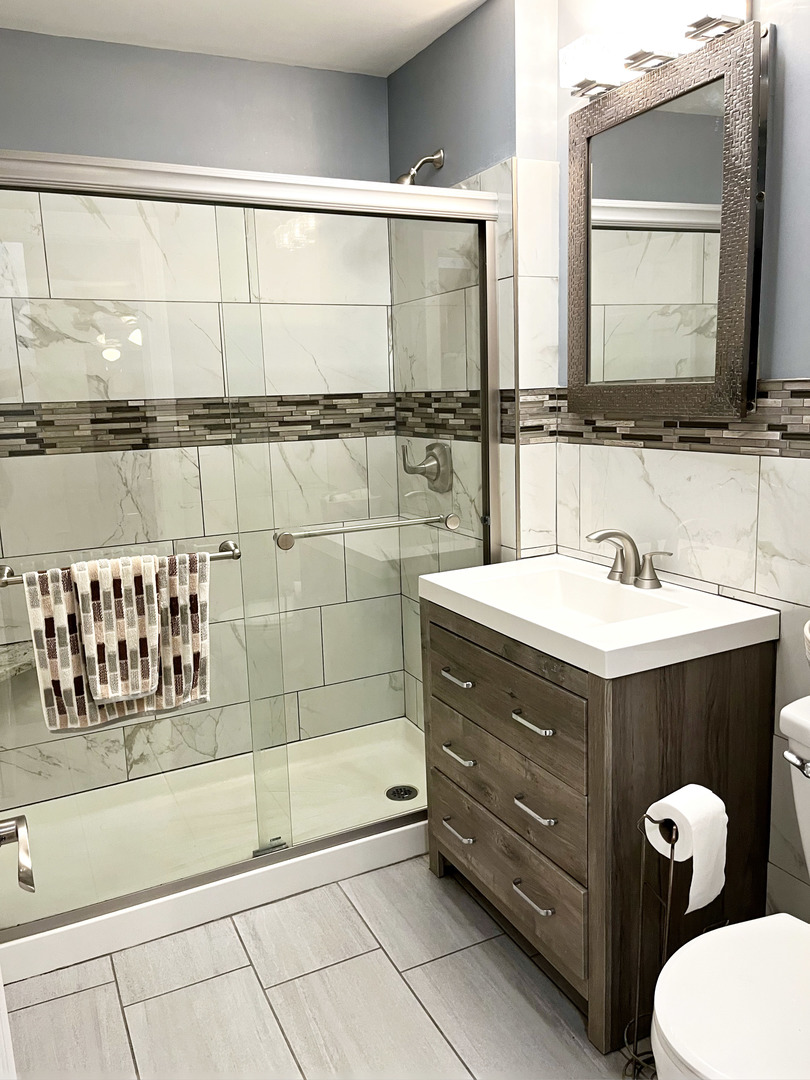 736 Dempster Street, Unit 110 Mount Prospect, IL 60056 - Photo 9 of 20 a bathroom with a double vanity sink and mirror
