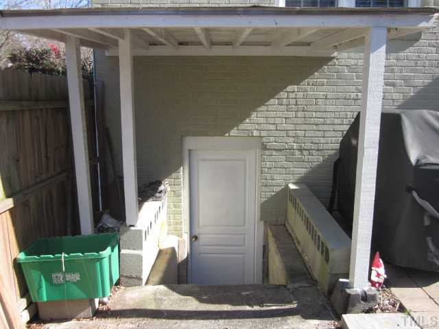 2031 Reaves Drive Raleigh, NC 27608 - Photo 11 of 25 Covered entrance to very clean basement area! Great space for storage or workshop area! Side driveway is wide enough for 2 cars! Basement