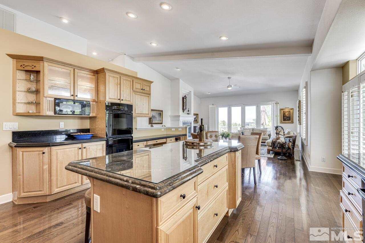 4370 Juniper Trail Reno, NV 89519 - Photo 15 of 40 a kitchen with stainless steel appliances granite countertop a refrigerator a stove top oven a sink dishwasher and white cabinets with wooden floor