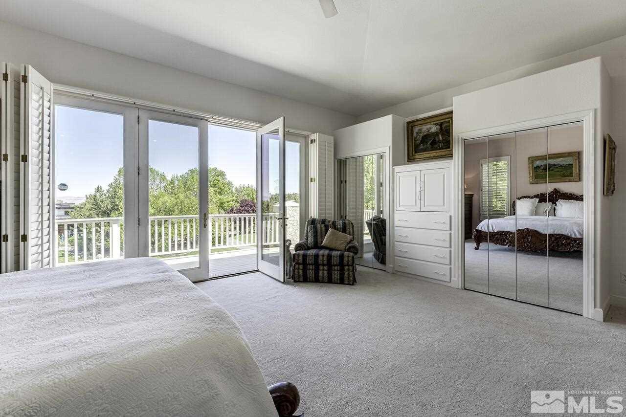 4370 Juniper Trail Reno, NV 89519 - Photo 25 of 40 a spacious bedroom with a bed and a large window