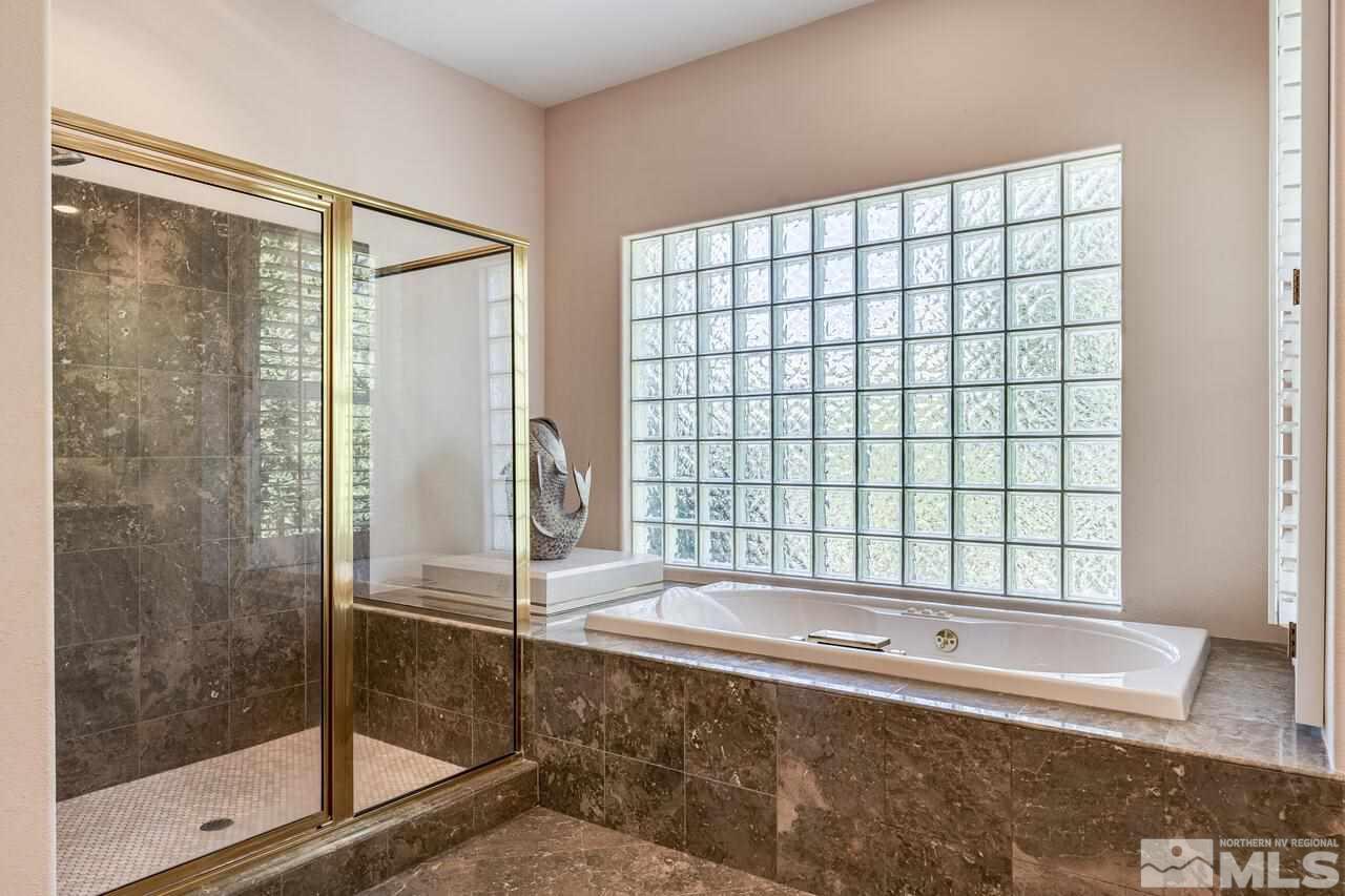4370 Juniper Trail Reno, NV 89519 - Photo 27 of 40 a bathroom with a bathtub and a shower