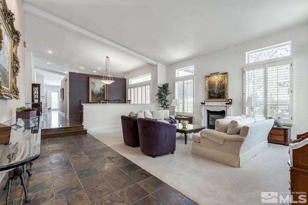 4370 Juniper Trail Reno, NV 89519 - Photo 7 of 40 a living room with furniture a flat screen tv and a large window